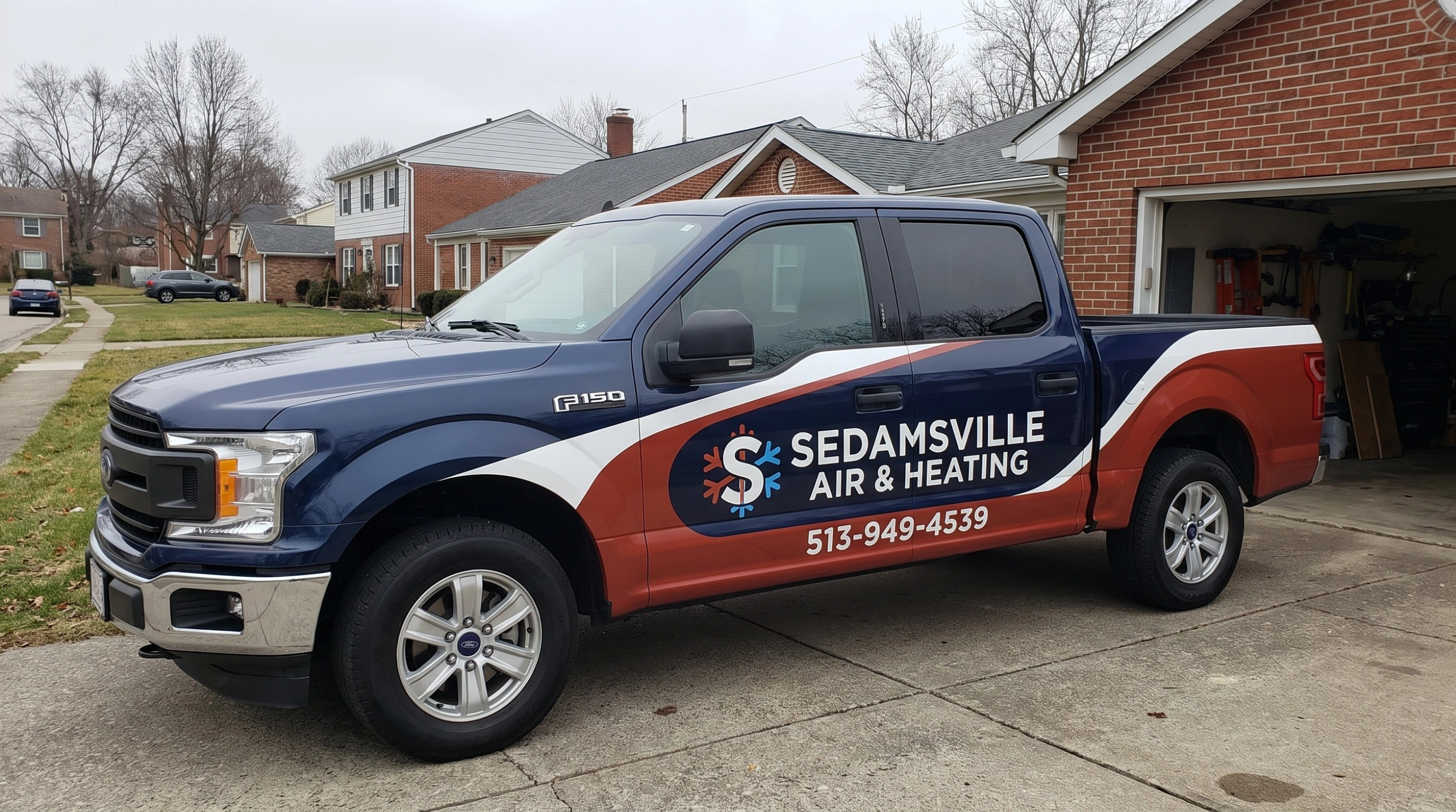 HVAC technician servicing a heating and cooling system in Cincinnati, OH